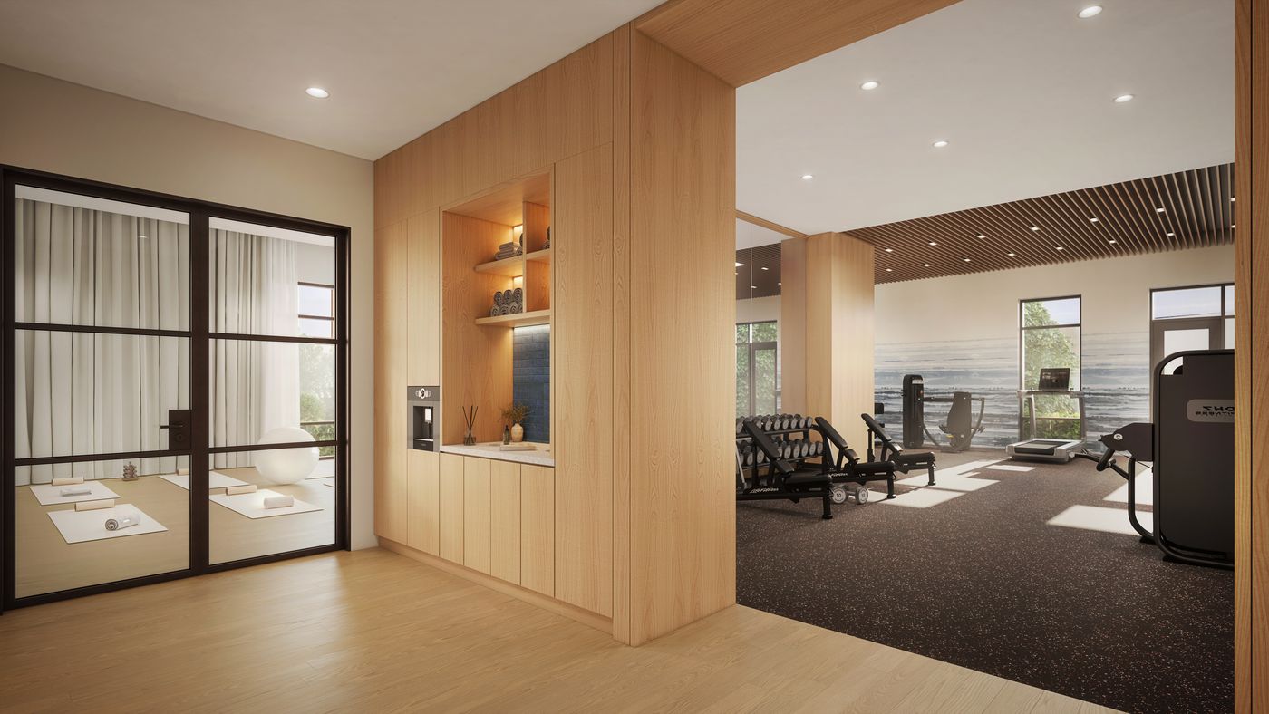 The Stillwater fitness centre, with cardio and strength equipment and a separate glass-walled studio for yoga and stretching.