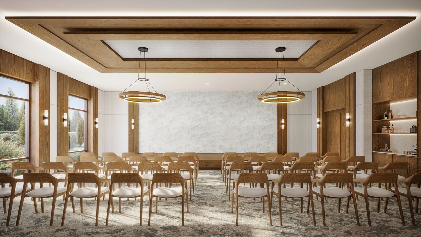 The Stillwater multipurpose room, set with rows of seating for a presentation and a serving counter along one wall.